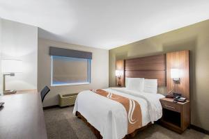 a hotel room with a large bed and a window at Quality Inn Mishawaka - South Bend in Mishawaka +21 photos