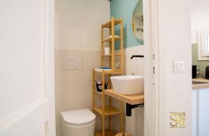 a bathroom with a sink and a toilet at Petit Buragna in Alghero