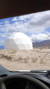 a view of a white dome from a car window at AK chatyr in Tong