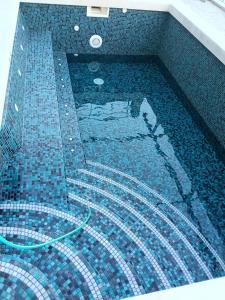 a swimming pool with a blue tiled floor at House Teresa - private pool in Praiano +18 photos