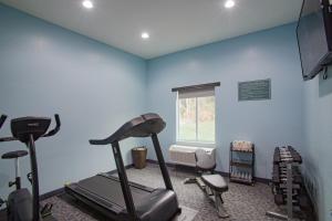 um ginásio com equipamento de exercício numa sala com paredes azuis em Iris Garden Inn em Savannah