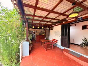 an outdoor patio with a wooden pergola at Villa Ouis NamKhan River View in Luang Prabang