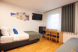 a hotel room with a bed and a table and chairs at Boutique Hotel Loka in Škofja Loka