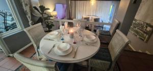 a white table with chairs and a candle on it at Derby in Lakeside +7 photos