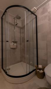 a shower with a glass door in a bathroom at Pakhuis Bed and Breakfast Unique in Enschede +19 photos