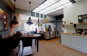 a kitchen with a dining table and a living room at Pakhuis Bed and Breakfast Unique in Enschede