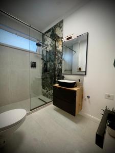 a bathroom with a sink and a glass shower at VerdeViu Apartments 3 Thermalis Residence Sânmartin Oradea Băile Felix 1 in Sînmartin +33 photos
