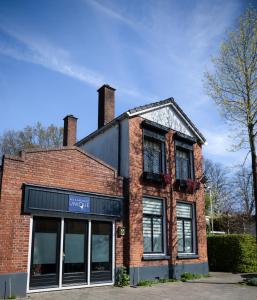 a brick building with a sign on it at Pakhuis Bed and Breakfast Unique in Enschede