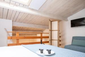 a room with a bed and a couch and a table at Casa del Vicolo in Alghero