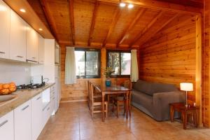 a kitchen and living room with a table and a couch at Camping Ribamar in Alcossebre