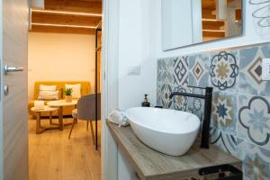 a bathroom with a white sink on a counter at Casa del Vicolo in Alghero +32 photos