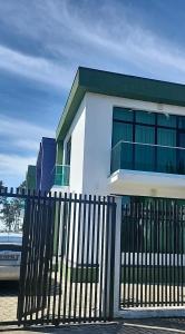 a white building with a fence in front of it at Gurgen Cottage in Ureki