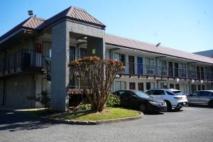a building with cars parked in a parking lot at Western Inn Marietta in Atlanta