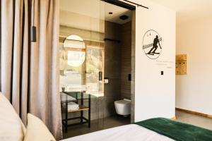 a bedroom with a glass door leading to a bathroom at Wierzbowa16 in Szczyrk +79 photos