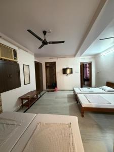 a large room with two beds and a ceiling at BOBY HOME STAY "BOBY MANSION" Jaipur in Jaipur +50 photos