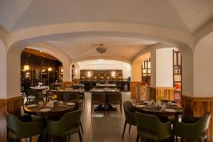 a restaurant with tables and chairs in a room at Udaan Hotel Pine Crest, Pelling in Pelling