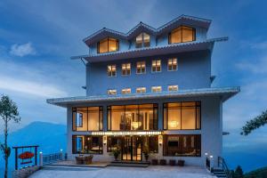 a large building with many windows at Udaan Hotel Pine Crest, Pelling in Pelling