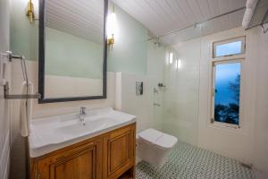 a bathroom with a sink and a toilet at Udaan Hotel Pine Crest, Pelling in Pelling +40 photos