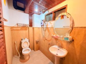 a bathroom with a sink and a toilet and a mirror at Villa Ouis NamKhan River View in Luang Prabang +64 photos
