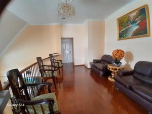 a living room with a couch and chairs at Villa Dinar Mountain Estate in Lembang