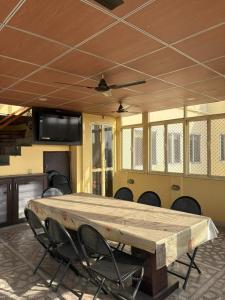 a large wooden table in a room with chairs at BOBY HOME STAY "BOBY MANSION" Jaipur in Jaipur
