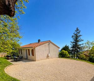 a small house with a gravel driveway in front of it at L'évasion viticole Clim- cour fermée & parking privé au pied de la roche de Solutré in Solutré-Pouilly