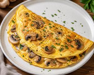 a omelet with mushrooms on a white plate at Kabir's Chalet Shangarh in Shangarh