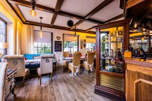 a restaurant with a dining room with a table and chairs at Landhaus Brockenblick in Hohegeiß