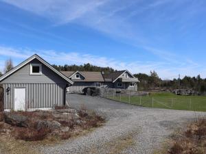 a house with a gravel driveway in front of a house at 7 person holiday home in Risør in Risør