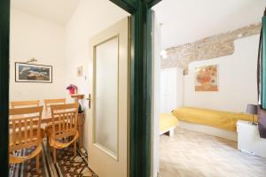 a room with a dining table and a bedroom at Apartment Poluotok in Zadar