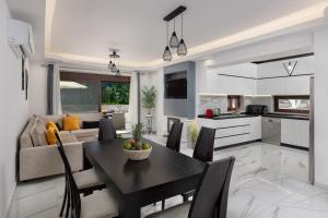 a kitchen and living room with a table and chairs at Oasis Luxury Villa in Rhodes Town +83 photos