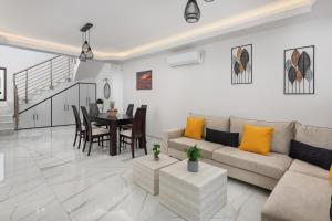a living room with a couch and a table at Oasis Luxury Villa in Rhodes Town