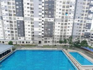 a large swimming pool in front of a large building at D'Camellia 43500 Semenyih Homestay in Semenyih