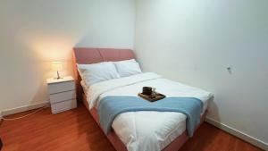 a small bedroom with a bed with a candle on it at D'Camellia 43500 Semenyih Homestay in Semenyih