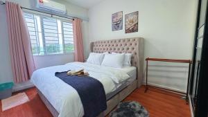 a bedroom with a bed with two shoes on it at D'Camellia 43500 Semenyih Homestay in Semenyih