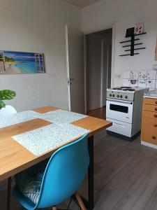 a kitchen with a table and a stove at Siisti valoisa kolmio in Lieksa