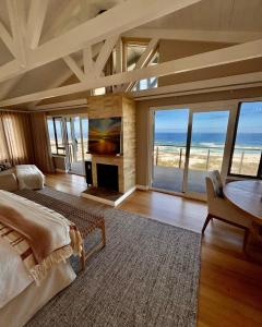 a bedroom with a bed and a view of the ocean at Dune Rose Yzerfontein Villa in Yzerfontein