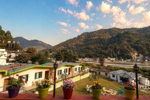 a view of a town with mountains in the background at Aqua Tree Resort in Rishīkesh