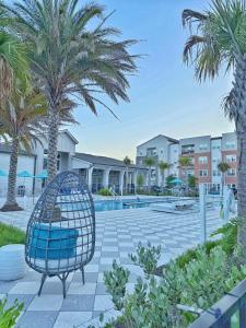 a chair sitting in a courtyard with palm trees at Beachline Oasis in Jacksonville