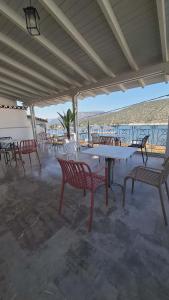 a group of tables and chairs on a patio at Zoe Pension in Ermioni