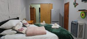 a bedroom with a bed with two stuffed animals on it at Malan's Siësta 2 in Kimberley