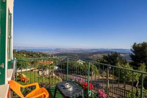 a balcony with a table and chairs and a view at דונה דינה Donna Dina in Amirim
