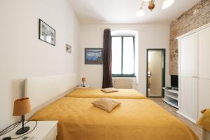 a bedroom with two beds and a window at Apartment Poluotok in Zadar