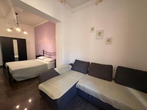 a living room with a couch and two beds at LightHouse - Casa di Luce in Reggio di Calabria