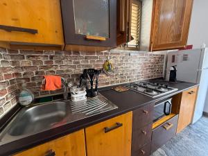 a kitchen with a sink and a stove at LightHouse - Casa di Luce in Reggio di Calabria +26 photos