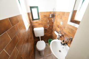 a small bathroom with a toilet and a sink at Apartment Poluotok in Zadar +33 photos