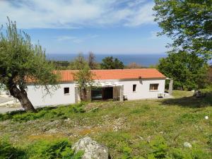 a white house with an orange roof at Forest and Sea view villas in Samothraki
