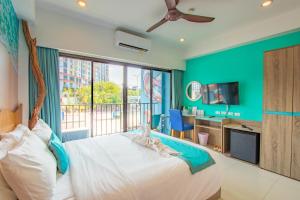 a bedroom with a bed and a large window at Jomtien Beach Sleep Inn - Steps from Beach & Market in Jomtien Beach