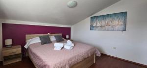 a bedroom with a bed with towels on it at Apartman NANE in Rab +55 photos