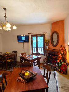 a living room with a table and a dining room at pasithea mountain rooms in Fylaktí +28 photos